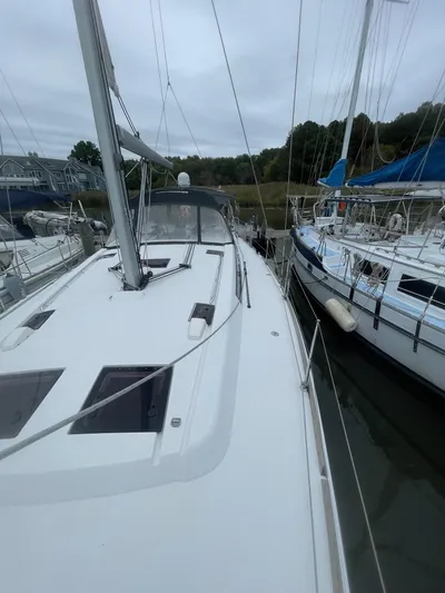 Joie De Vivre Yacht Photos Pics 2014 Beneteau Oceanis 48 sailboat docked alongside other vessels.