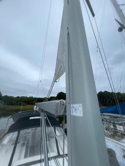 Joie De Vivre Yacht Photos Pics 2014 Beneteau Oceanis 48 sailboat mast and deck view under cloudy sky.