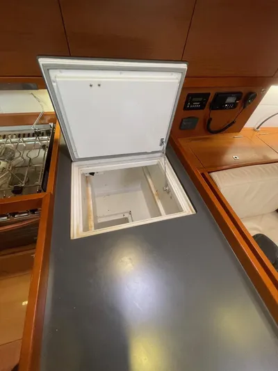 Joie De Vivre Yacht Photos Pics Beneteau Oceanis 48 yacht interior, 2014 model, featuring an open storage compartment in the kitchen area.