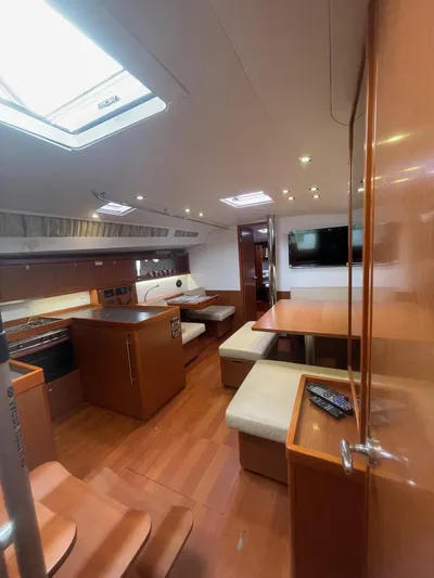 Joie De Vivre Yacht Photos Pics Interior of 2014 Beneteau Oceanis 48 yacht with modern kitchen and seating area.