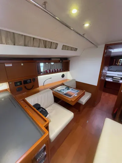 Joie De Vivre Yacht Photos Pics Interior of 2014 Beneteau Oceanis 48 yacht with cozy seating and wooden finishes.