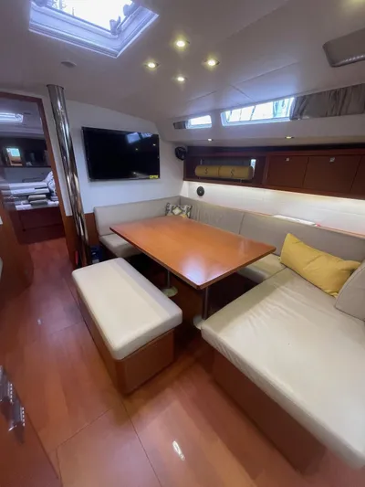 Joie De Vivre Yacht Photos Pics 2014 Beneteau Oceanis 48 interior with modern dining area and comfortable seating.