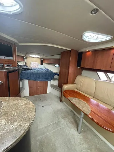  Yacht Photos Pics 2009 Cruisers Yachts 360 Express interior with bed, sofa, and table.