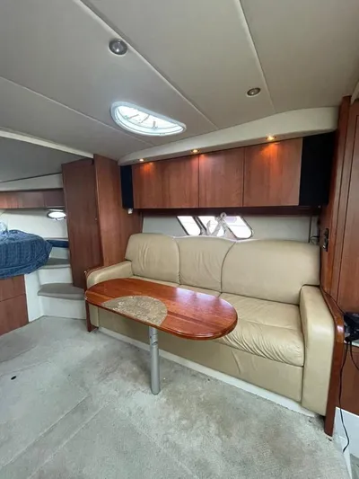  Yacht Photos Pics Interior of 2009 Cruisers Yachts 360 Express with beige sofa and wooden table.