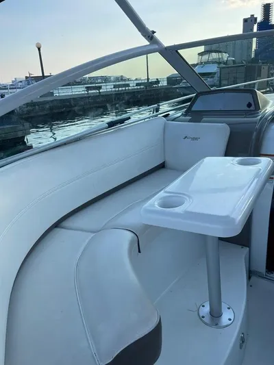  Yacht Photos Pics 2009 Cruisers Yachts 360 Express interior with seating and table, docked by the waterfront.