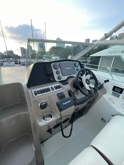  Yacht Photos Pics 2009 Cruisers Yachts 360 Express helm with steering wheel and navigation controls.