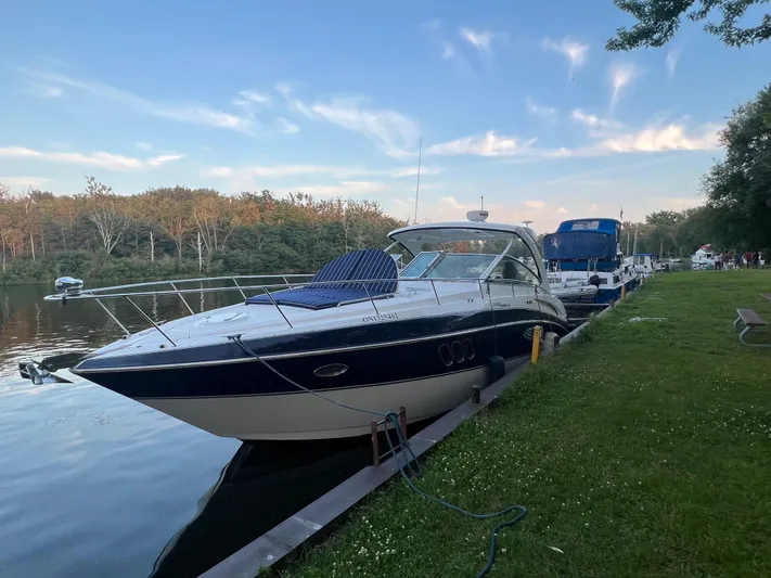  Yacht Photos Pics 2009 Cruisers Yachts 360 Express docked by a serene riverside under a clear sky.