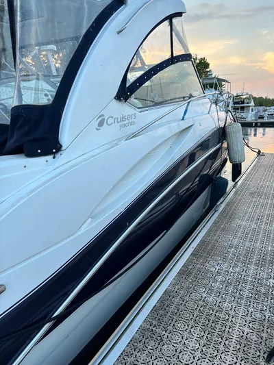  Yacht Photos Pics 2009 Cruisers Yachts 360 Express docked at sunset, showcasing sleek design and luxury features.