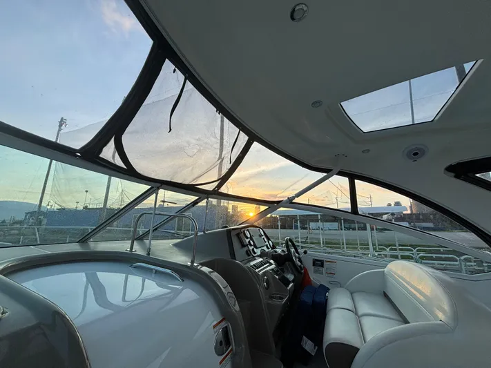  Yacht Photos Pics 2009 Cruisers Yachts 360 Express interior with sunset view through windows.