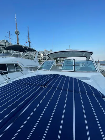  Yacht Photos Pics 2009 Cruisers Yachts 360 Express docked, featuring a striped deck cover and cityscape background.