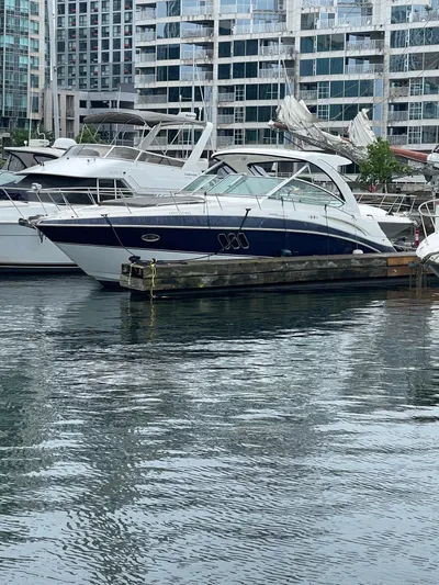  Yacht Photos Pics 2009 Cruisers Yachts 360 Express docked in a marina with modern buildings in the background.