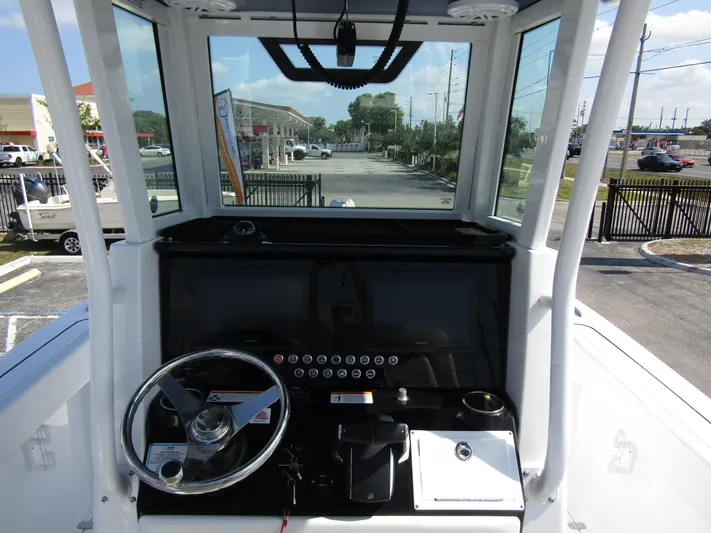  Yacht Photos Pics 2024 Wellcraft 263 Fisherman boat helm with steering wheel and control panel.