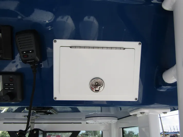  Yacht Photos Pics 2024 Wellcraft 263 Fisherman boat console with storage compartment and communication equipment.