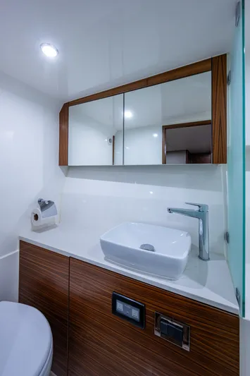 Ciento Siete Yacht Photos Pics Modern bathroom in 2020 Maritimo X50 yacht with sleek sink and wooden cabinetry.