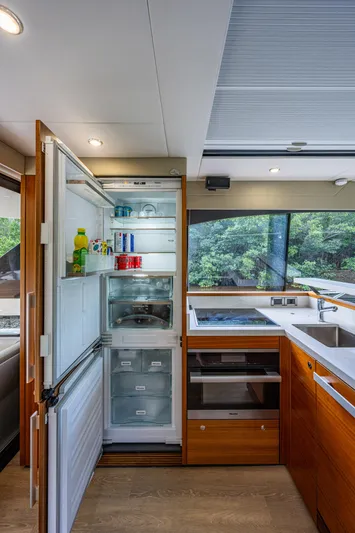 Ciento Siete Yacht Photos Pics Modern kitchen in 2020 Maritimo X50 yacht with open fridge and sleek appliances.
