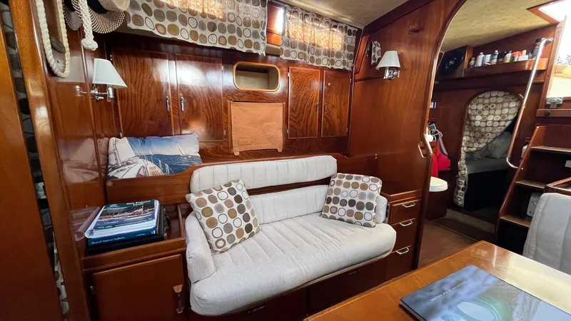 Indigo Yacht Photos Pics Interior of 1996 Amel Super Maramu-53 yacht with cozy seating and wooden finish.