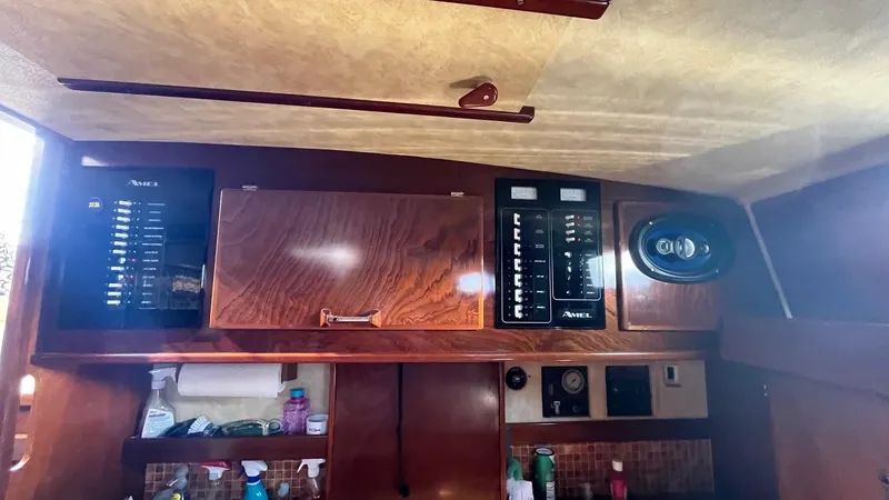 Indigo Yacht Photos Pics Interior view of 1996 Amel Super Maramu-53 yacht with control panels and storage.