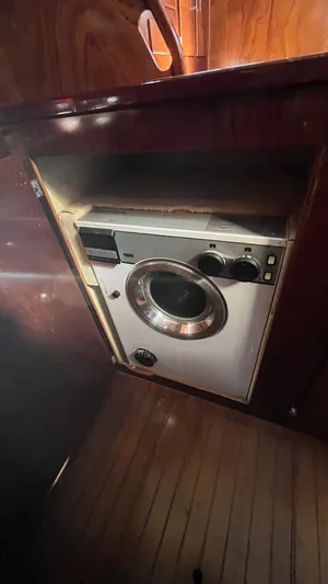 Indigo Yacht Photos Pics Washing machine inside 1996 Amel Super Maramu-53 yacht, wooden interior.