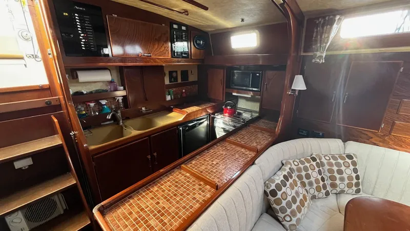 Indigo Yacht Photos Pics Interior of 1996 Amel Super Maramu-53 yacht with cozy kitchen and seating area.