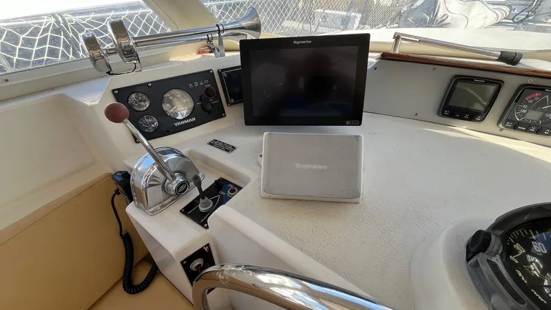 Indigo Yacht Photos Pics 1996 Amel Super Maramu-53 yacht cockpit with navigation instruments and controls.
