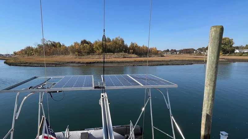Indigo Yacht Photos Pics Sailboat with solar panels on calm water, Amel Super Maramu-53, 1996 model.