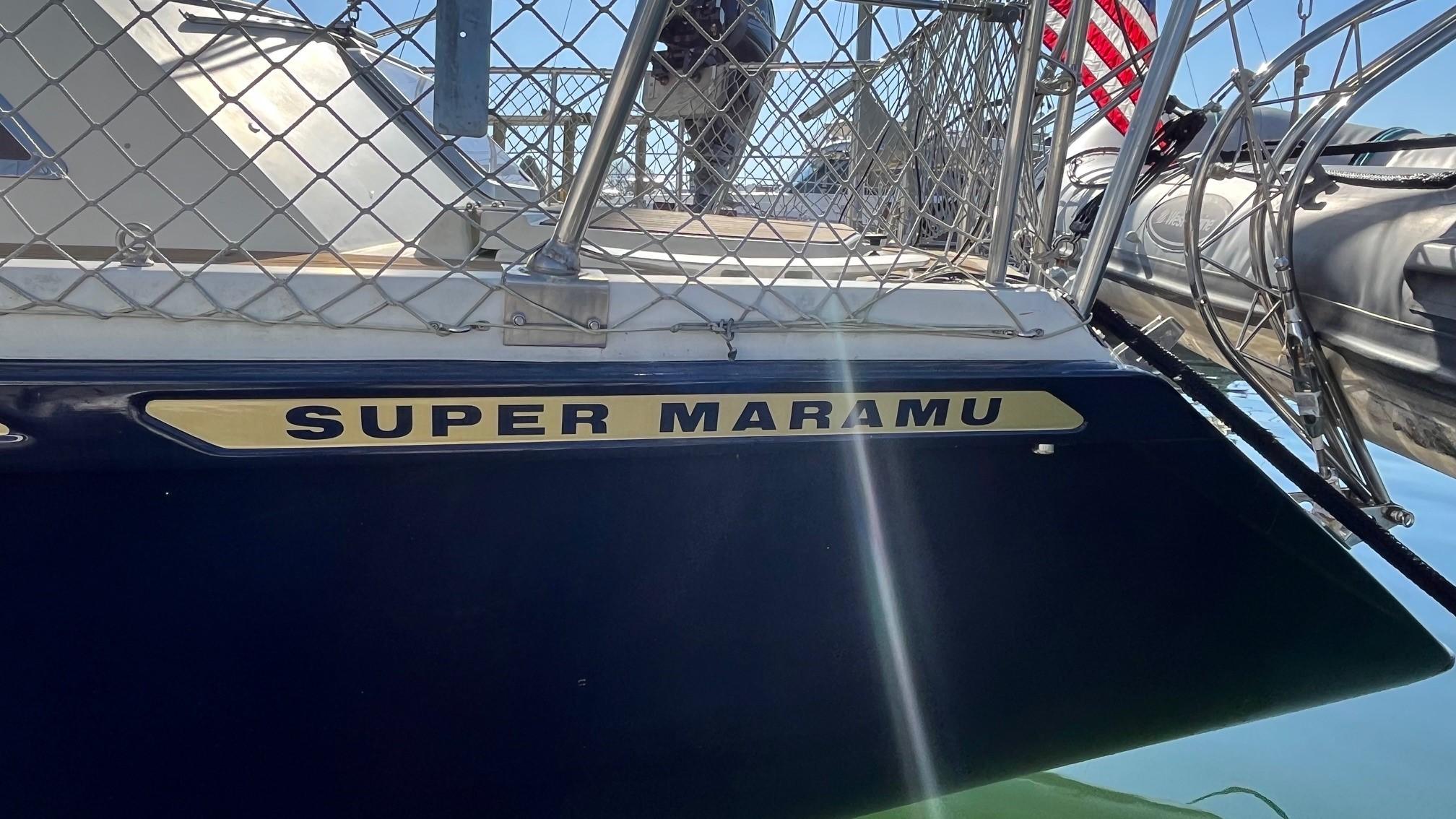 1996 Amel Super Maramu-53 sailboat docked, featuring nameplate and railing.