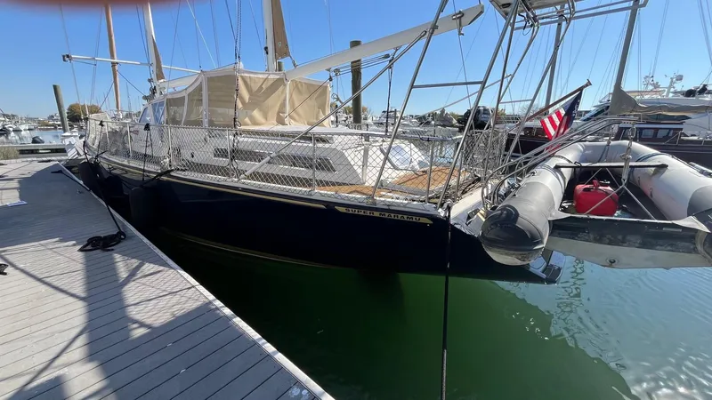 Indigo Yacht Photos Pics 1996 Amel Super Maramu-53 sailboat docked, featuring sleek design and American flag.