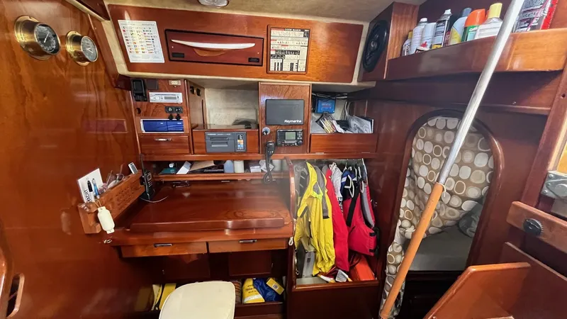 Indigo Yacht Photos Pics Navigation station of 1996 Amel Super Maramu-53 yacht with equipment and storage.