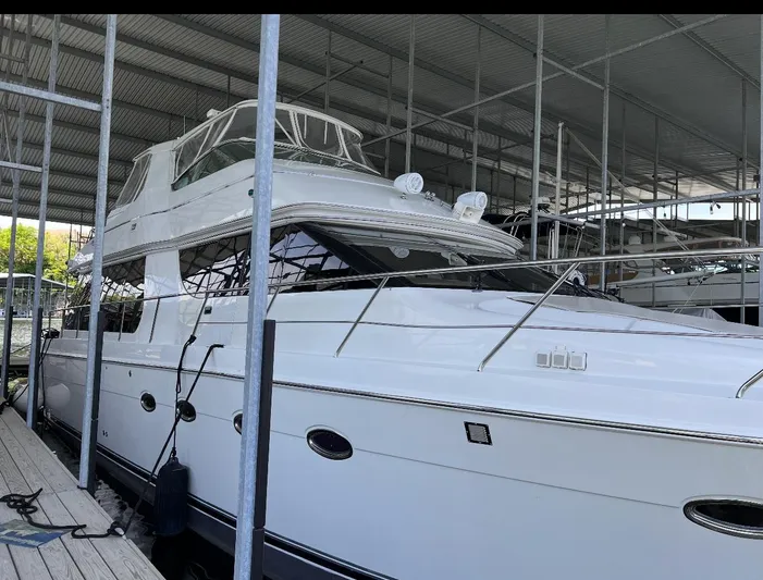 Flying Lady Yacht Photos Pics 2004 Carver 570 Voyager Pilothouse yacht docked in a covered marina.