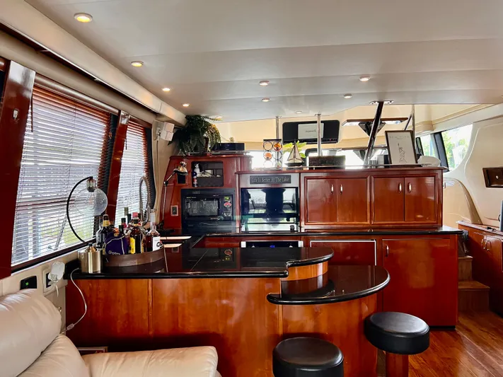 Flying Lady Yacht Photos Pics Luxurious interior of 2004 Carver 570 Voyager Pilothouse with elegant wood finishes and modern amenities.