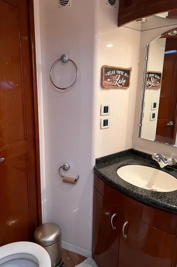 Flying Lady Yacht Photos Pics Bathroom interior of 2004 Carver 570 Voyager Pilothouse with sink, mirror, and decor.