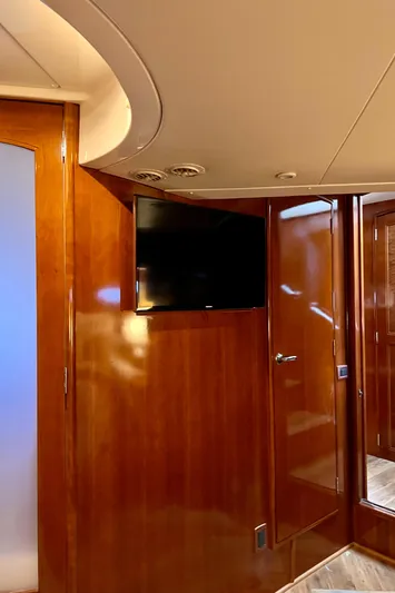 Flying Lady Yacht Photos Pics Interior of 2004 Carver 570 Voyager Pilothouse with wood paneling and mounted TV.