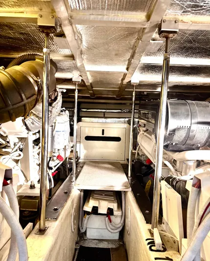 Flying Lady Yacht Photos Pics Engine room of 2004 Carver 570 Voyager Pilothouse, showcasing mechanical components and equipment.