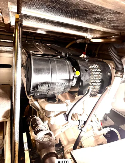 Flying Lady Yacht Photos Pics Engine room of 2004 Carver 570 Voyager Pilothouse, showcasing mechanical components and piping.