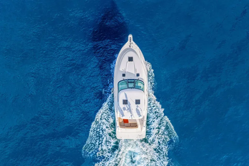  Yacht Photos Pics Aerial view of 2008 Tiara Yachts 4300 Sovran cruising on vibrant blue ocean.