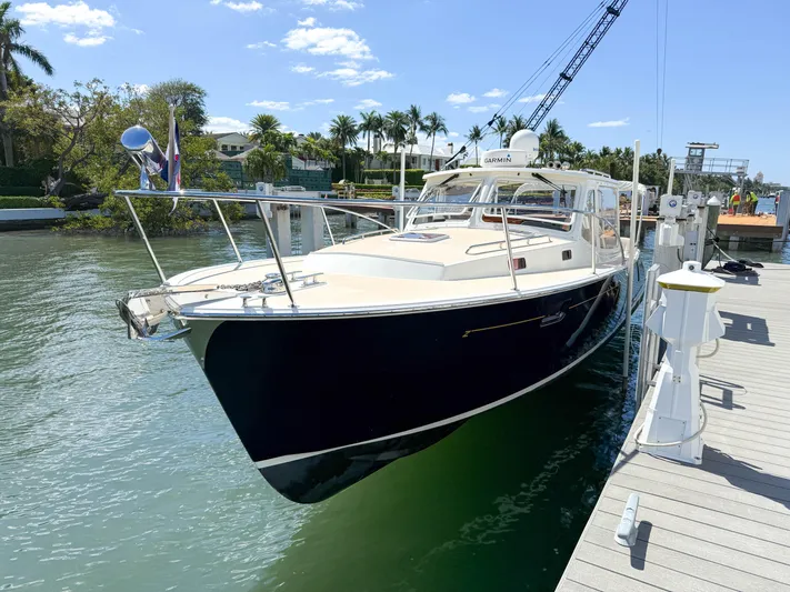 Moncri Yacht Photos Pics 2012 MJM 36z Downeast yacht docked by a sunny waterfront.