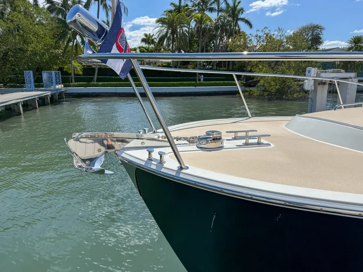 Moncri Yacht Photos Pics 2012 MJM 36z Downeast boat anchored by a tropical waterfront with palm trees.