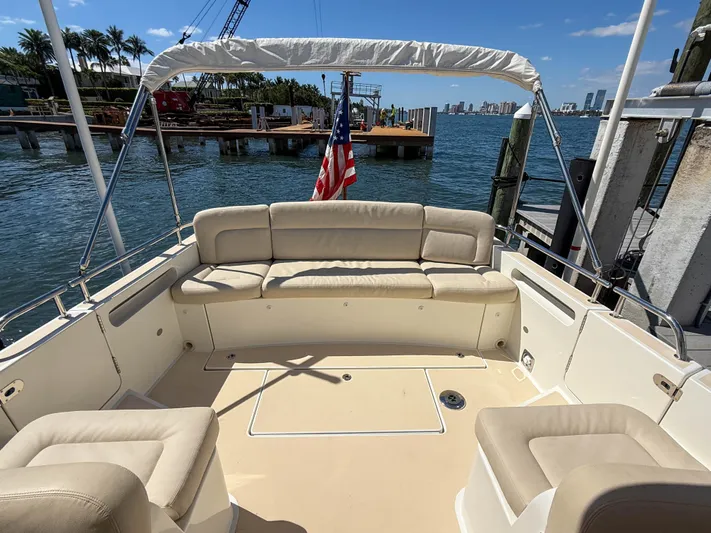 Moncri Yacht Photos Pics 2012 MJM 36z Downeast boat with spacious seating, docked by the waterfront.