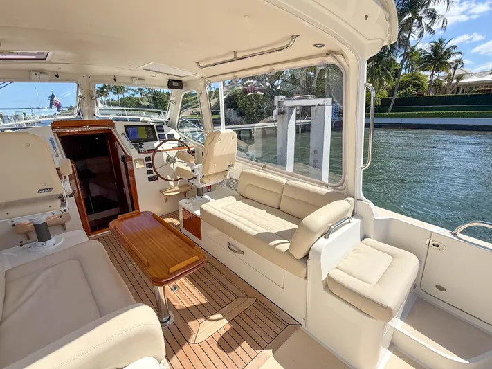 Moncri Yacht Photos Pics 2012 MJM 36z Downeast boat interior with seating, helm, and wooden table.