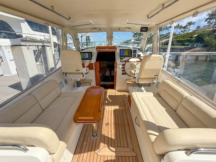 Moncri Yacht Photos Pics Luxurious interior of 2012 MJM 36z Downeast yacht with plush seating and wooden accents.