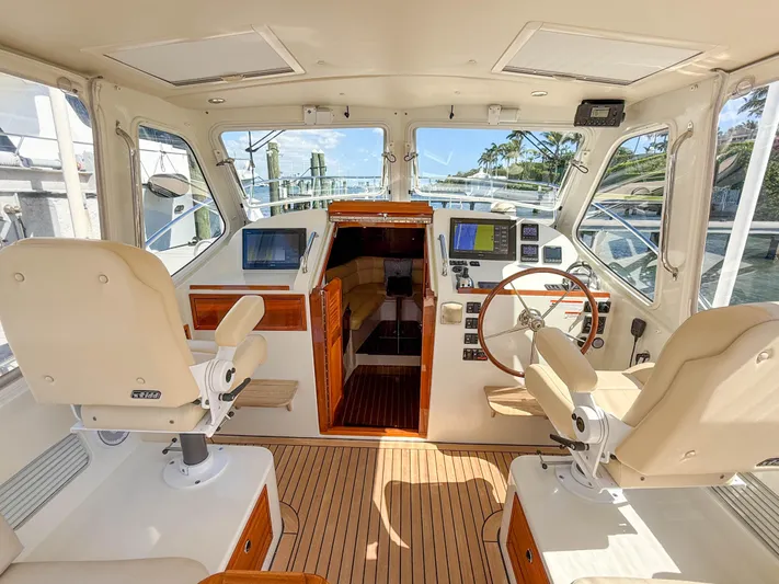 Moncri Yacht Photos Pics Interior of 2012 MJM 36z Downeast boat with helm, seating, and navigation equipment.