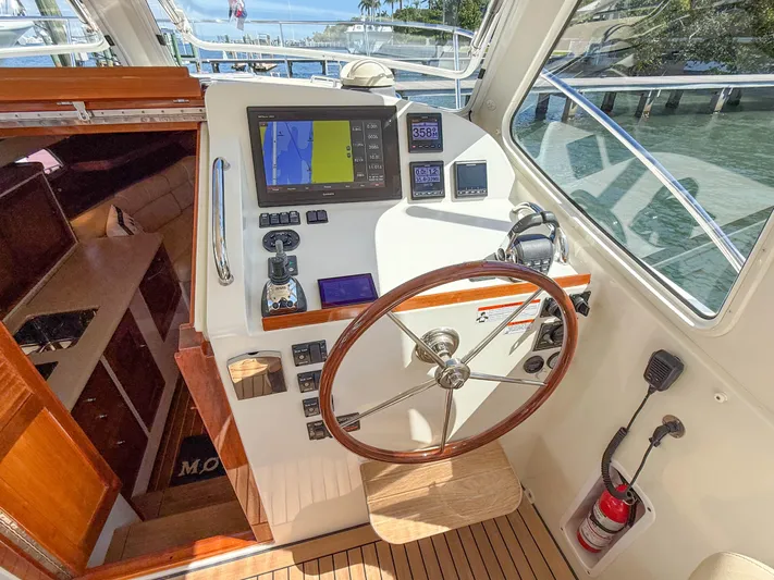 Moncri Yacht Photos Pics Helm of 2012 MJM 36z Downeast boat with navigation equipment and wooden steering wheel.