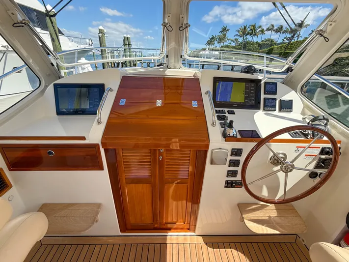 Moncri Yacht Photos Pics 2012 MJM 36z Downeast yacht helm with wooden accents and modern navigation equipment.