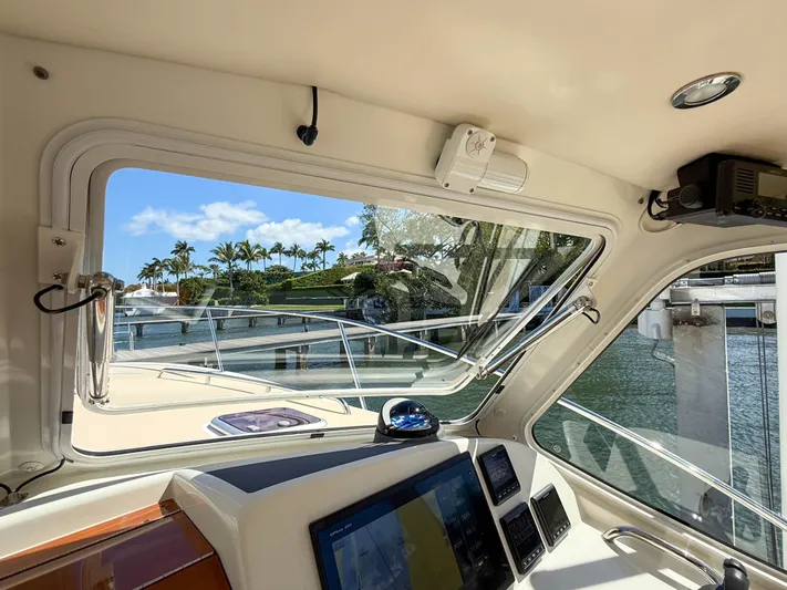 Moncri Yacht Photos Pics Interior view of 2012 MJM 36z Downeast yacht, showcasing dashboard and marina scenery.