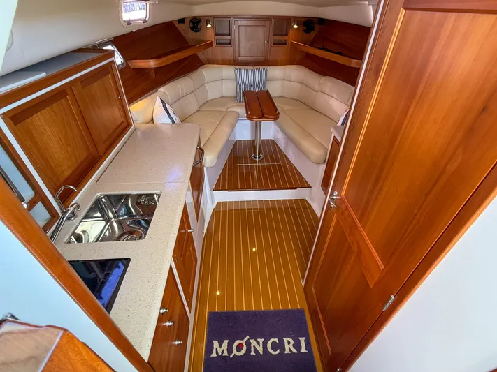 Moncri Yacht Photos Pics Luxurious interior of 2012 MJM 36z Downeast yacht with wood finishes and cozy seating.