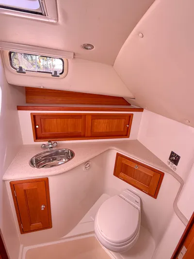 Moncri Yacht Photos Pics 2012 MJM 36z Downeast yacht bathroom with wooden cabinets and compact design.