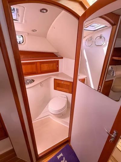 Moncri Yacht Photos Pics 2012 MJM 36z Downeast yacht bathroom with wooden cabinetry and modern fixtures.