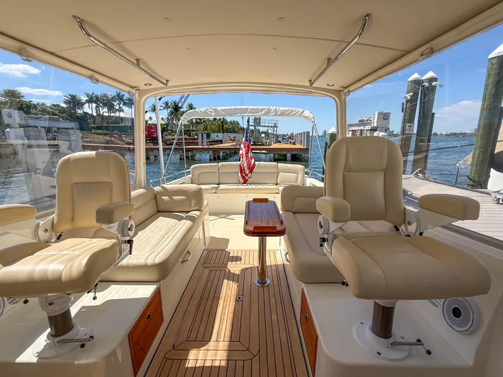 Moncri Yacht Photos Pics Interior of 2012 MJM 36z Downeast boat with beige seating and wooden flooring.
