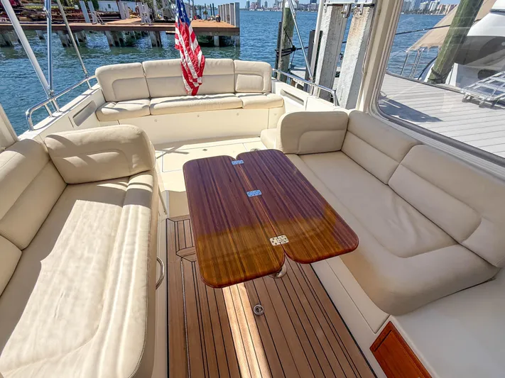 Moncri Yacht Photos Pics Luxurious seating area on a 2012 MJM 36z Downeast yacht with wooden table.