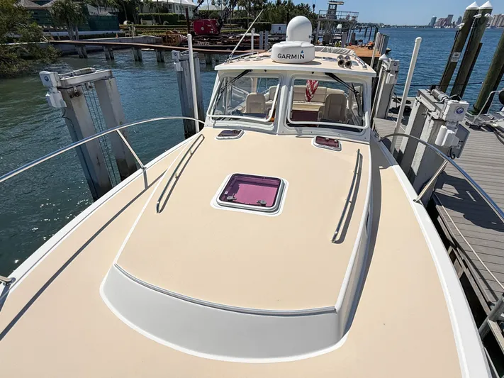 Moncri Yacht Photos Pics 2012 MJM 36z Downeast boat docked, featuring a Garmin system and spacious deck.